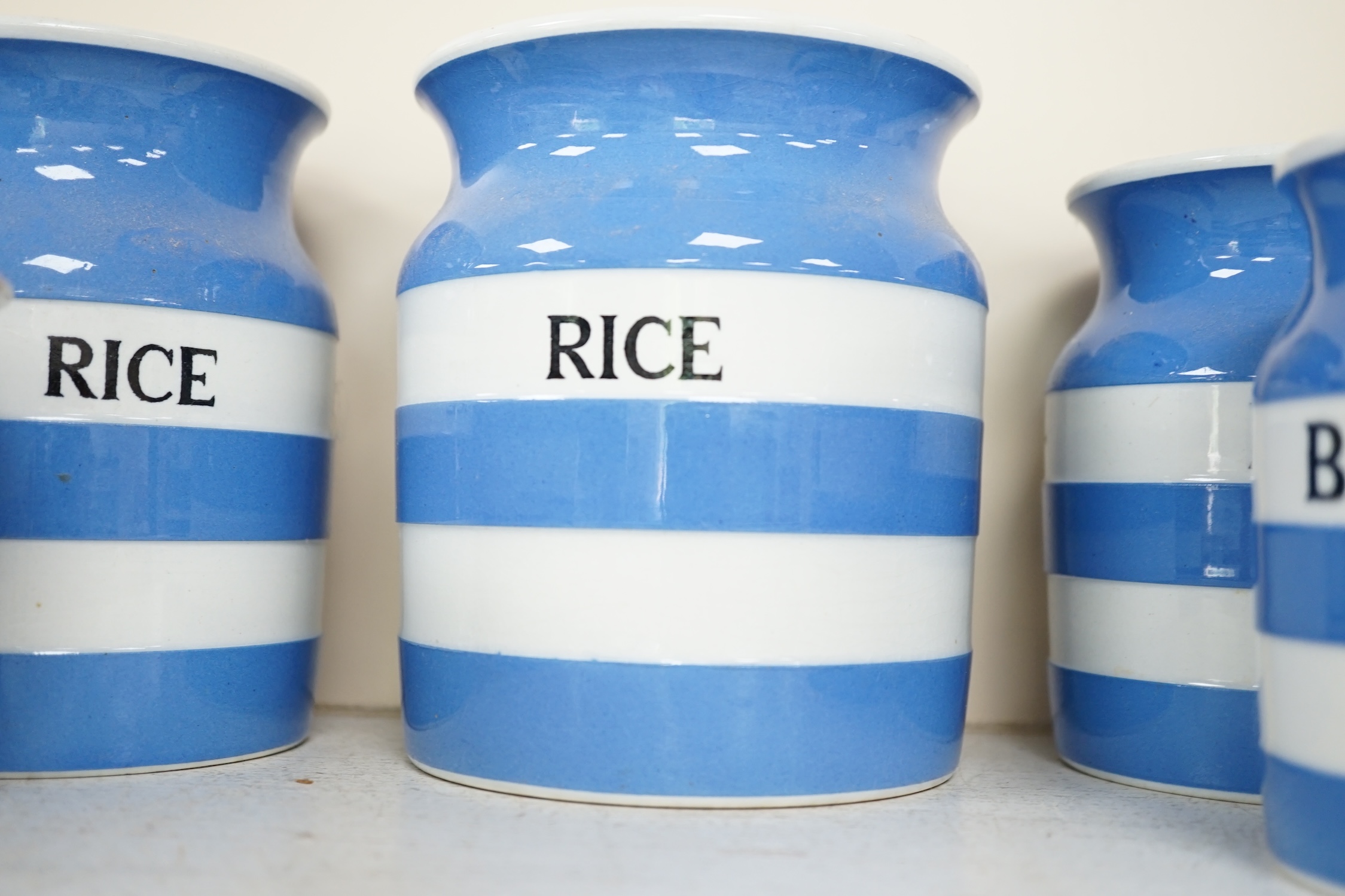 T.G.Green Cornish Kitchenware, fifteen lidded storage jars, to include Moist Sugar, Spaghetti, Semolina, Patna Rice, Brown Rice, Butter and Lard, largest 14cm high, Black Shield marks. Condition - poor, fair and good